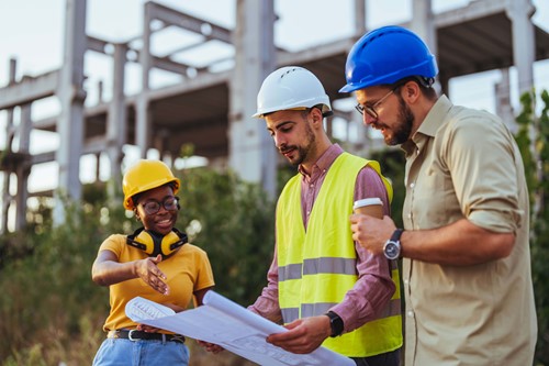 workers looking at construction sketches 